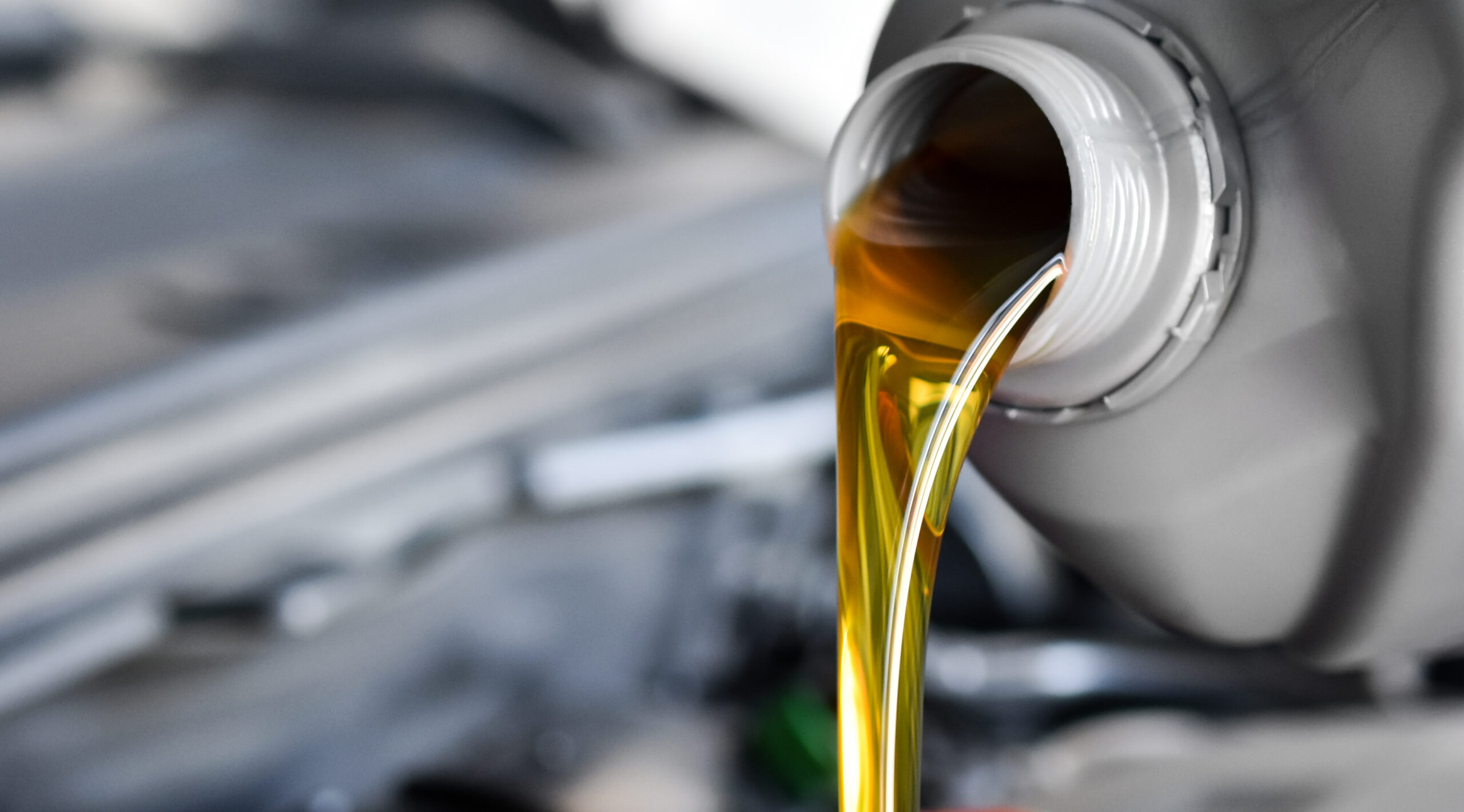 Image of oil being poured into a vehicle